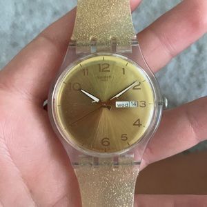 Swatch watch is glittery gold
